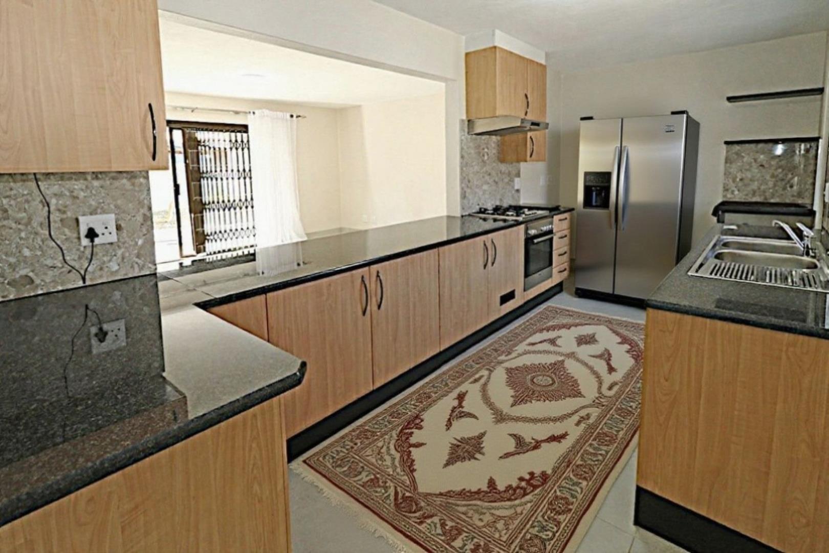 754946_kitchen_with_beigh_carpet_and_fridge_no_water_mark.jpeg